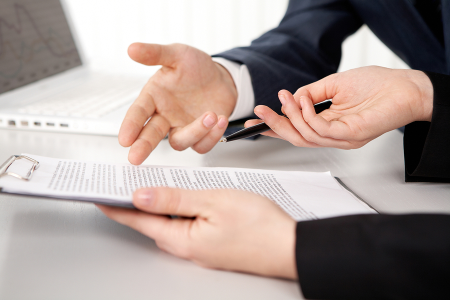 Hands of two businesspeople discussing a contract